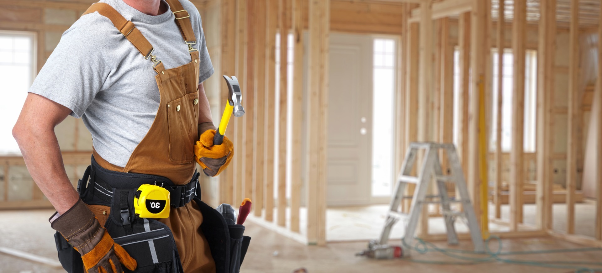 Man holding tools inside a property renovation.
